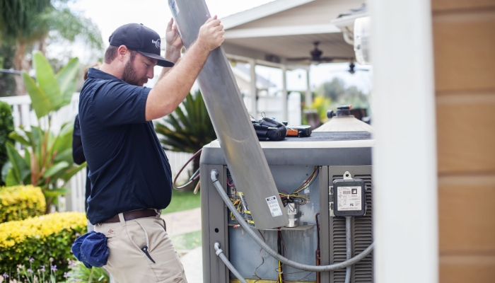 Technician Replacing Panel On Unit